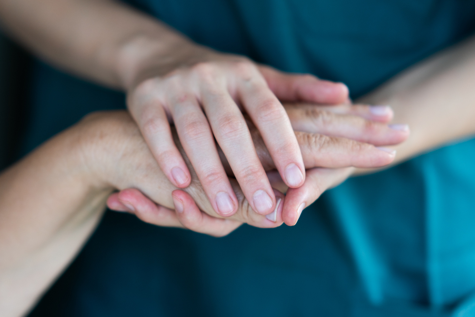 Healthcare nurse caring for the elderly concept - holding hands