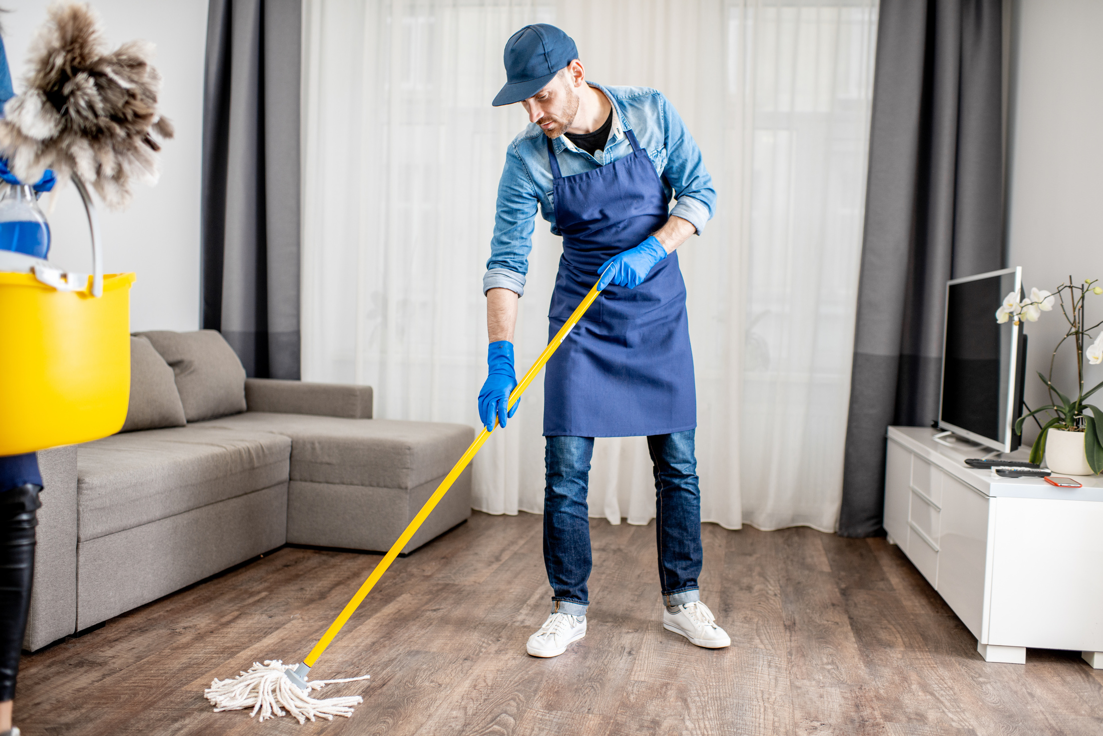 Housekeeper Mopping the Apartment Floor